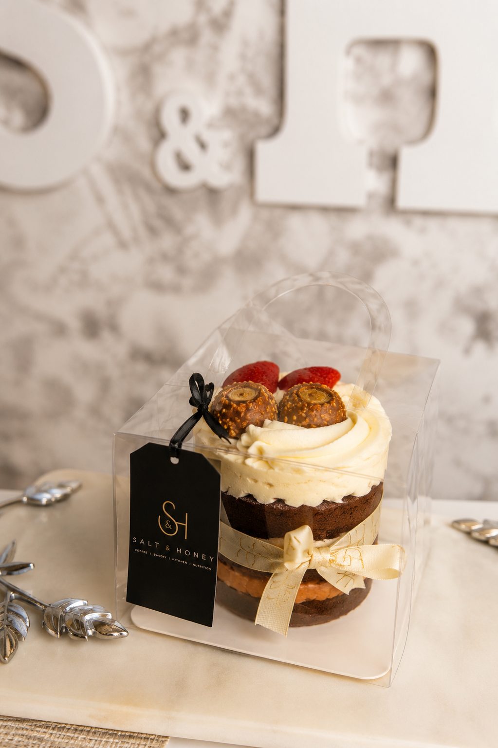Petite celebration cake boxed with a Salt and Honey tag